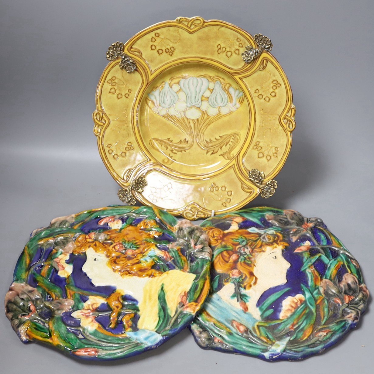 Two Continental Art Nouveau style plaques and a brass mounted dish, dish 31.5 cms diameter.